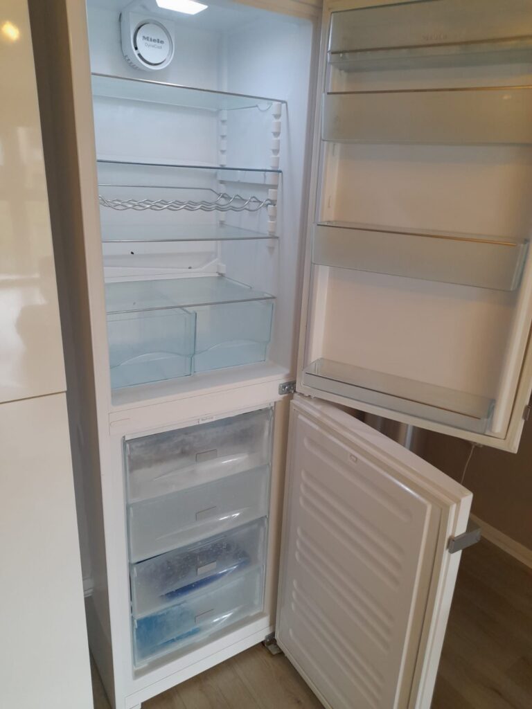 fridge cleaning services London professional cleaner sanitising refrigerator interior and removing dirt
